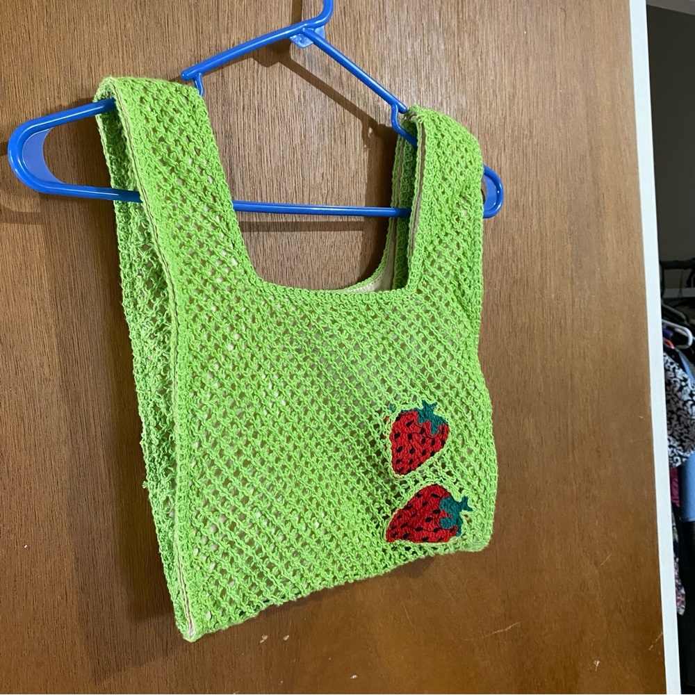 Green and red knitted or crocheted strawberry bag
